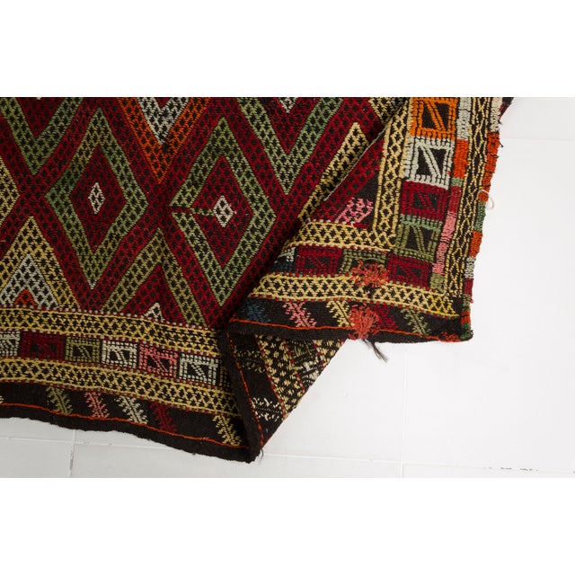 This is a vintage Turkish Oushak rug from the Mid 20th Century. The piece was hand-knotted.
