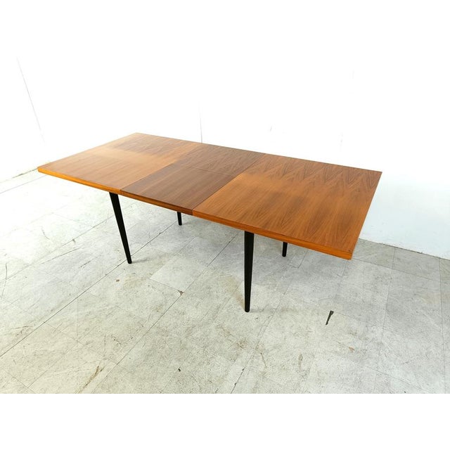 Mid century extendable dining tabled esigned by Belgian Designer Jos De Mey. It has two extra table tops that fold out...