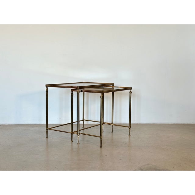 Two 1970s coffee tables, bronze and brass structure, smoked glass tops, the smaller table measures 48h.x51x35 cm.