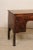 An Italian smaller-sized carved-wood desk, with pull-out writing shelf and storage, from the 19th century. This antique...