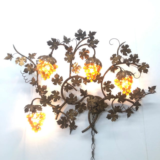 Extraordinary, large wall sculpture with 4 amber Murano glass grape clusters that glow warmly, when lit. Original gilt...