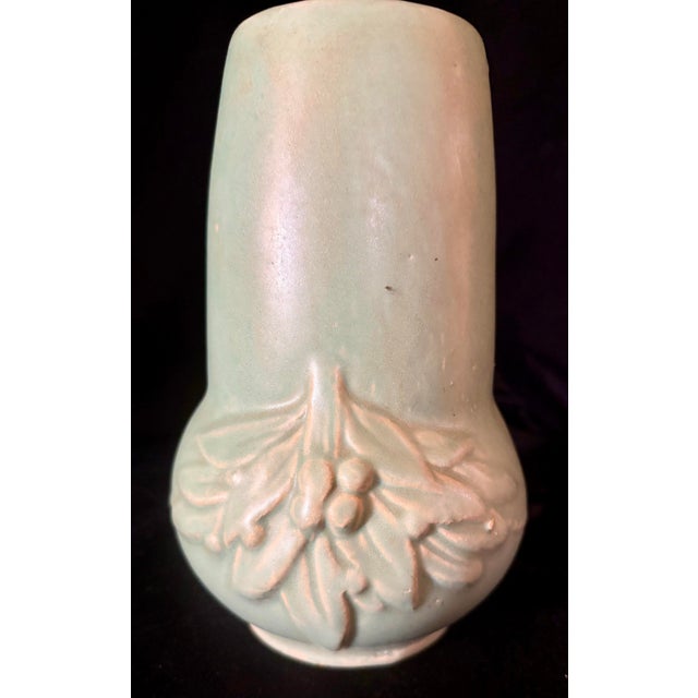 This vessel serves as a collectible display item, emblematic of early 20th century American Pottery design. It features a...