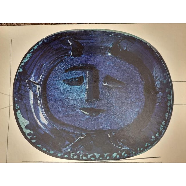 An exquisite shiny polychrome print of Picasso Vallauris ceramic plate depicting face in blue. The color print is attached...