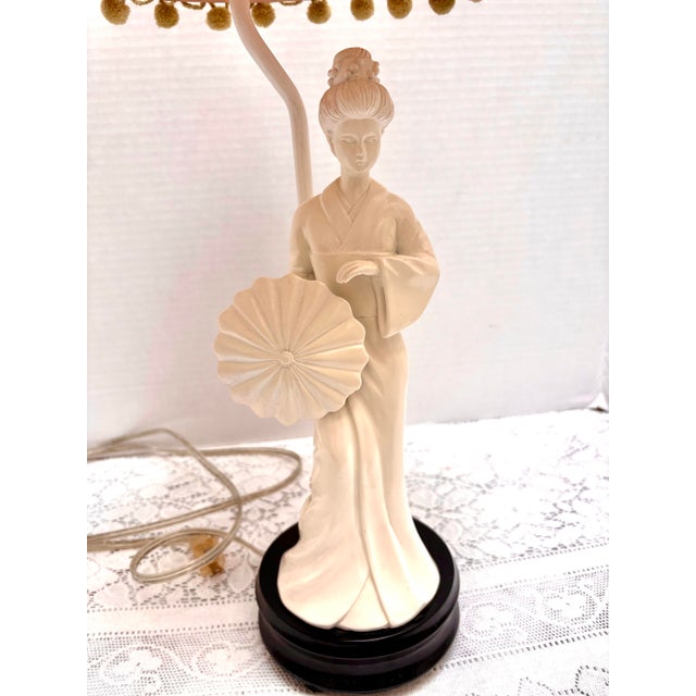 Vintage soft white geisha girl with parasol table lamp with natural burlap shade with Pom poms. Unique whimsical and...