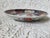 An Imari style plate or shallow bowl from Arita, Japan. In the traditional colors red, blue and gold. It measures 8 ¾”...