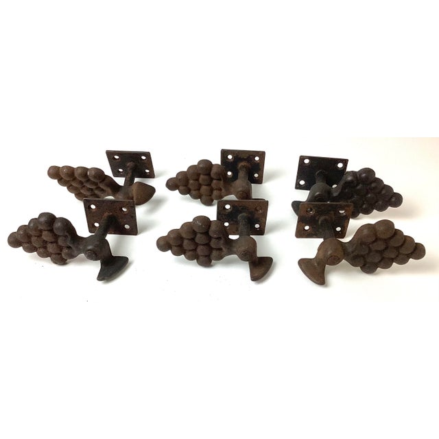 Antique Cast Iron Grape Shutter Dogs set of 6. Each shutter dog measures 5 1/2 inches long by 3 1/4 inches deep and 3...