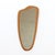 This mid-century wall mounted mirror was made in England during the 1960s. The mirror has an asymmetrical shape and would...