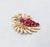 1960s goldtone round faux-garnets and small round clear rhinestones brooch with security clasp. Marked crown "TRIFARI©."...