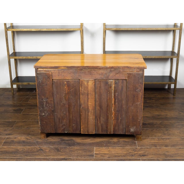 An Austrian Biedermeier commode from the 19th century, with three drawers and block feet. Created in Austria during the...