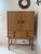 Light oak bar cabinet by Kurt Ostervig, 1960. This Danish wooden cabinet produced by K.P Mobler has two (2) doors that...