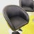 Set of four black faux leather swivel armchairs with chrome base.