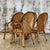This set of 4 vintage coastal arched pencil reed dining chairs adds breezy, tropical elegance to any dining space....
