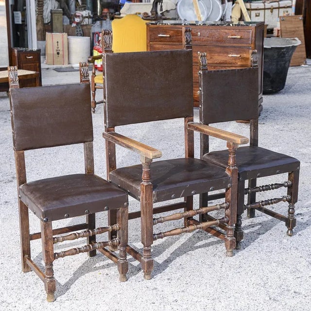 Set consisting of two chairs and a chair with throne armrests with an -like seat with carvings and bolts that finish the...
