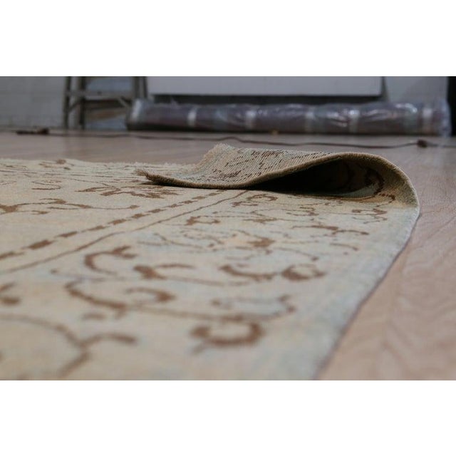 This green wool rug features a hand knotted pile construction and originates from China. It serves as a durable floor...