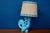 In a delicate Art Deco style, this charming lamp makes a delightful decorative piece. A beautifully stylized ceramic...