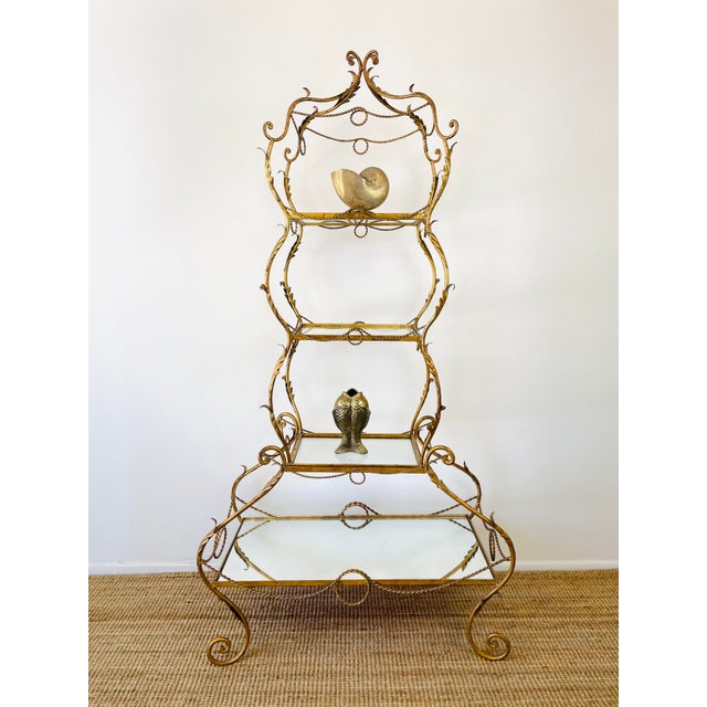 Vintage 1960s Gold Gilt Etagere made of metal gold gilt surface curvy tiered design with scroll detail acanthus leaves and...
