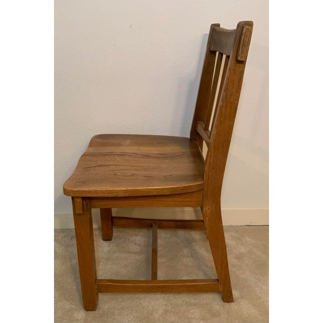 Vintage early American oak chair with spindle back and solid hand crafted construction.
