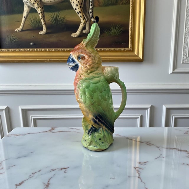 Bring a burst of French Art Deco whimsy to your collection with this exceptional St. Clément majolica parrot pitcher,...