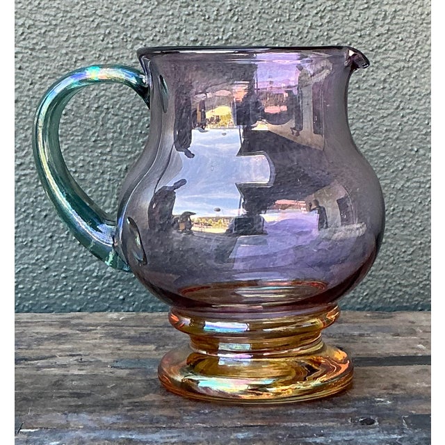 Brighten your tabletop service with this delightful vintage hand-blown art glass pitcher, a playful study in color and...