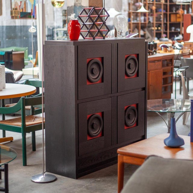 This black Brutalist buffet was designed in the 1970s. Each door panel has a circle-shaped doorknob and the interior...