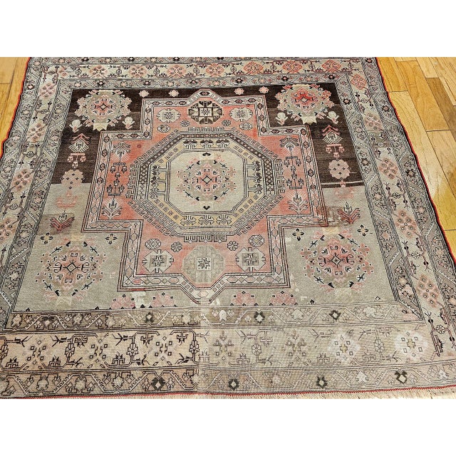 This early 20th century Turkish Oushak rug presents a rare and desirable near-square format — a proportion actively sought...