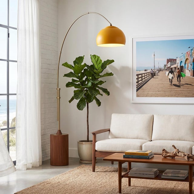 Weathered Brass steel paired with a Dark Walnut wood base defines the Tambo Arc Lamp, a Mid-Century Modern masterpiece...