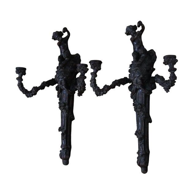Pair of late 20th century heavy bronze two arm candelabra wall sconces. Torchiere style wrapped in flowering vines...