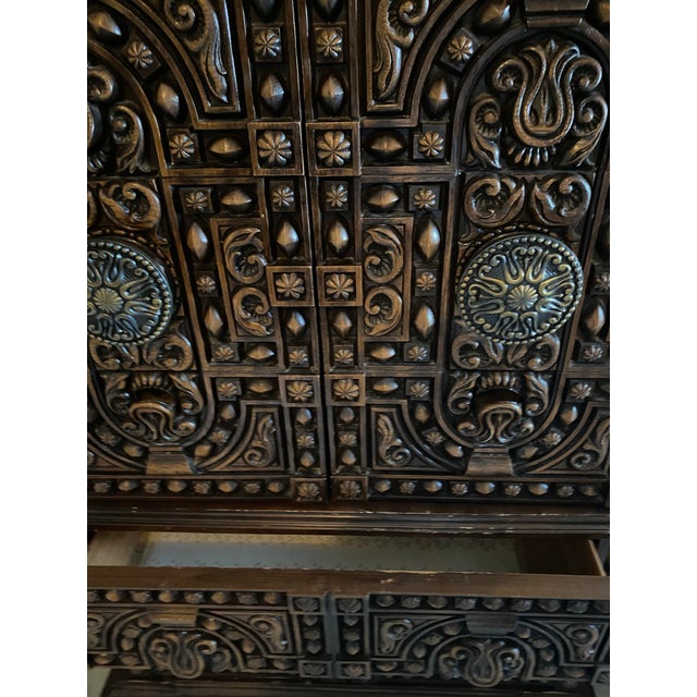 This is truly one of the most beautiful vintage mid century armoires I’ve ever seen. It features two doors on the top with...