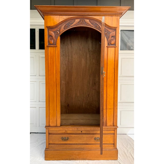 Here is a beautiful Edwardian English armoire cabinet, dating to around 1904, with attribution to Harris Lebus, as...