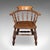 This is an antique country house captain's chair. An English, beech and elm smoker's bow or elbow seat, dating to the...