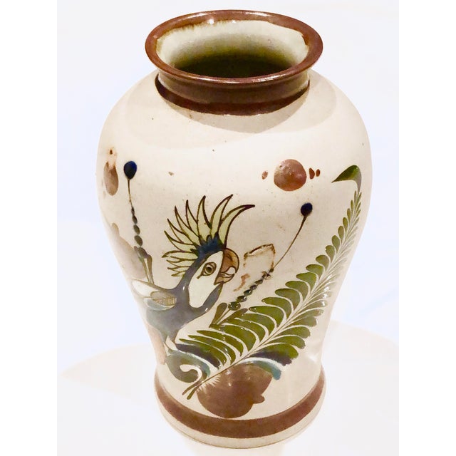 Lovely Tonala vase with Rare parrot illustration. Butterfly on back. Deep rich colors and sandstone base. Festive and...