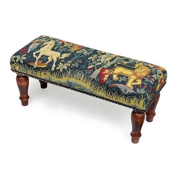 Meticulously handcrafted in the United Kingdom, this upholstered stool boasts classic studding and hand-polished solid...