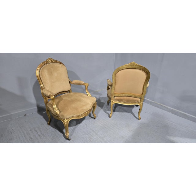 A wonderful pair French Gilt armchairs, covered in oatmeal suede, in excellent original condition. 39" high 28" overall...