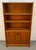 A beautifully crafted mid-century Danish modern bookcase in richly grained teak, offering the perfect balance of...