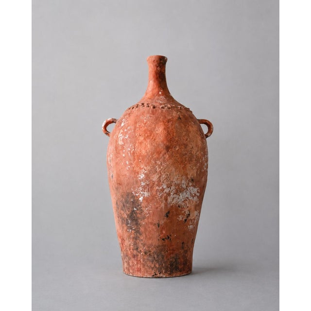 Evoking the quiet presence of an artifact unearthed from the Judean desert, this hand-sculpted vessel carries the...