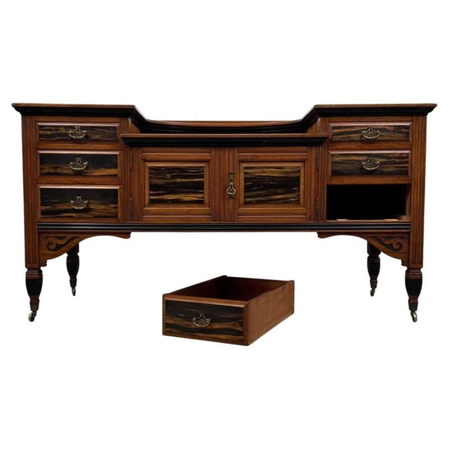A distinctive and exceptionally well-crafted 20th-century low sideboard, combining richly figured mahogany with...