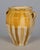 An earthenware confit pot from the Southwest of France with traditional yellow ochre drip glaze. Some losses to glaze....