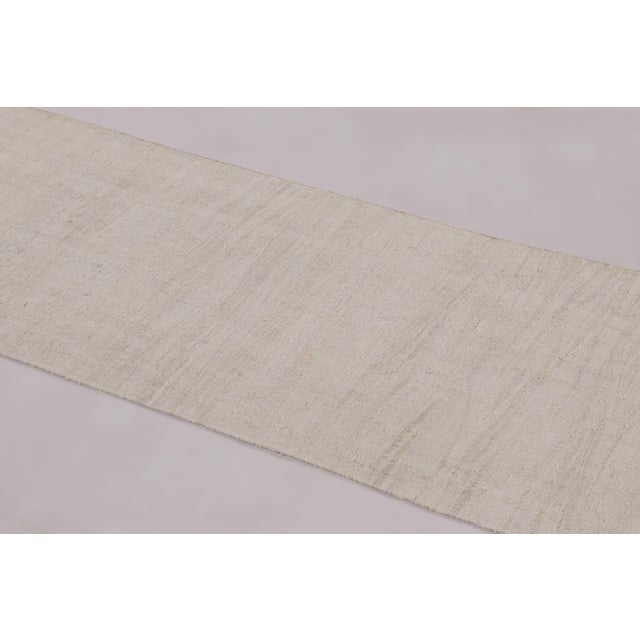 Made with handwoven wool in Turkey circa 1950-1960, this 2x8 vintage kilim runner is a particularly exciting, rare find in...