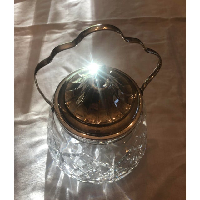 Silver plated brass handle and chiseled crystal glass are the main features of the small ice bucket. This glass piece was...