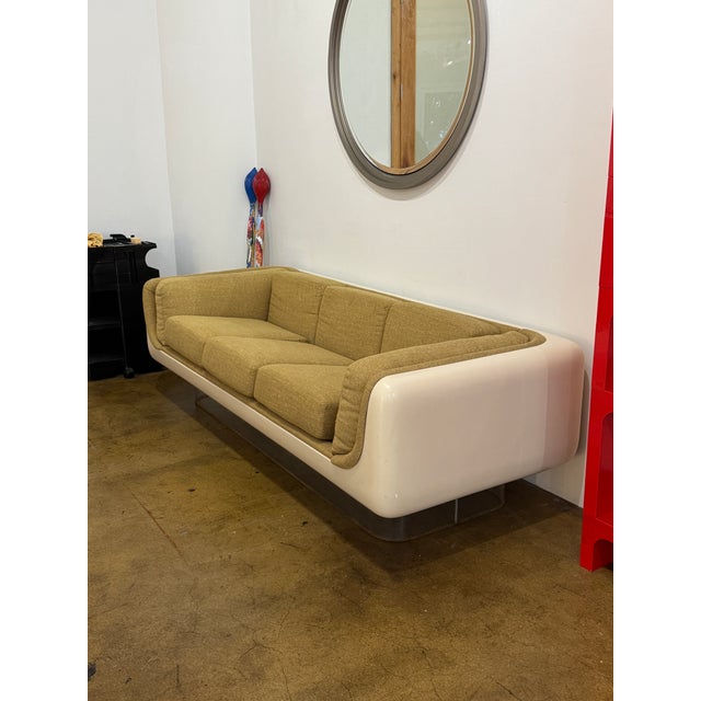 William Andrus Steelcase floating sofa, 1970s. Molded fiberglass shell with recessed lucite base.