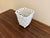 An elegant trompe l'oeil porcelain cachepot crafted in the form of a handwoven rope basket. Executed in glossy white...