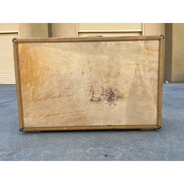 Vintage Hartmann Leather Belted Steamer Luggage Trunk. Light yellow/tan with darker edging. Light pink silk/quilted interior.