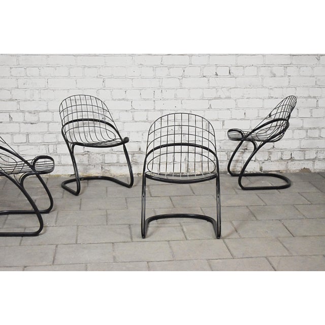 Vintage dining room chairs model 'Pascale' by Gastone Rinaldi for Thema, Italy. Set consists of 4 chairs with black metal...