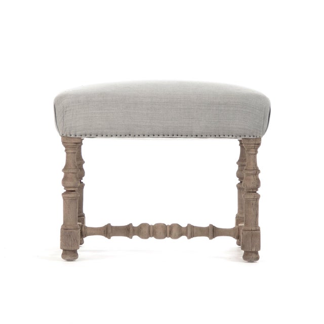 The Audrey Stool from Zentique is a French country backless stool with a blue linen padded seat on a natural dry oak frame...
