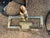 A handsome vintage brass fireplace companion set featuring a classic collection of hearth tools displayed on an elegant...