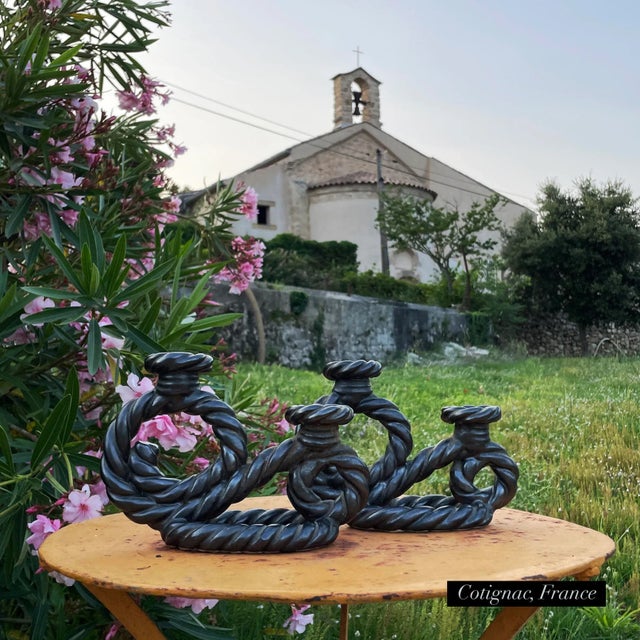 An incredible pair of Vallauris candlestick holders, in classic black luster glaze on twisted rope design. Mint condition,...