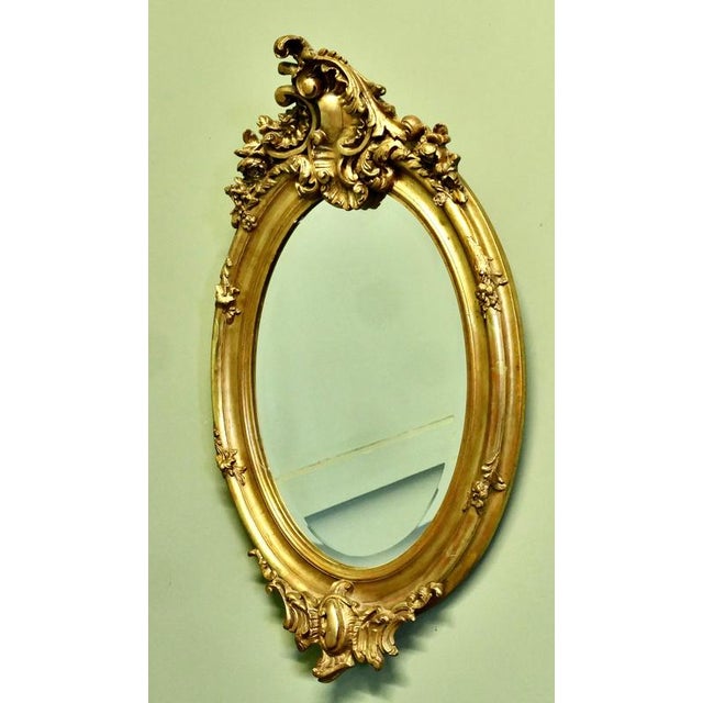 Classic Large French Rococo Oval Gilt Wall Mirror The Mirror has an exquisite Gold Leaf Frame in the Rococo Style, it is...