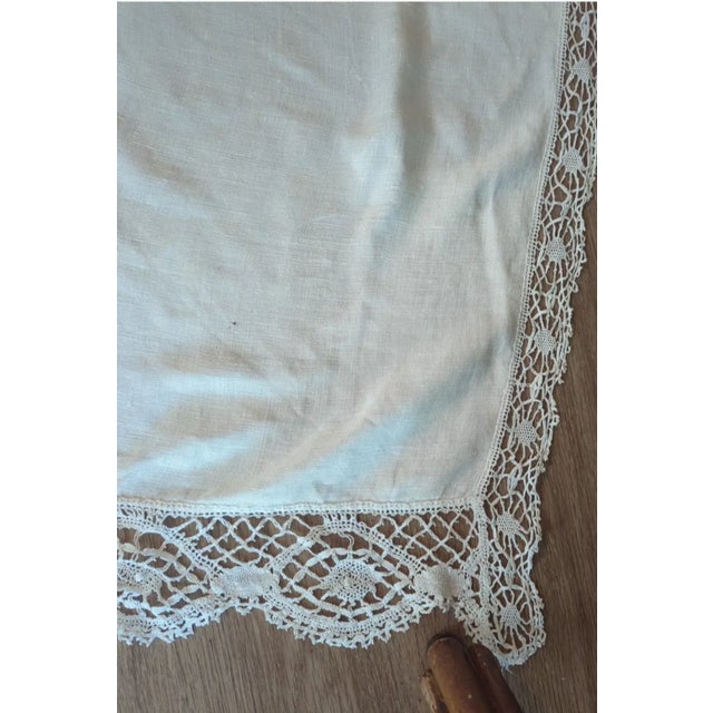 A grand antique banquet-size tablecloth, 84" x 68", hand-pieced from fine ecru linen panels joined with narrow lace...