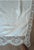 A grand antique banquet-size tablecloth, 84" x 68", hand-pieced from fine ecru linen panels joined with narrow lace...