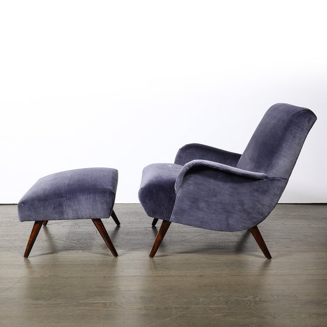 This Mid-Century Modern lounge chair and matching ottoman pair epitomize the sleek, thoughtful design of 1960s American...